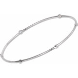Women's bangle bracelet features a round brilliant cut natural diamond. The diamond is bezel set in solid 14k white gold.