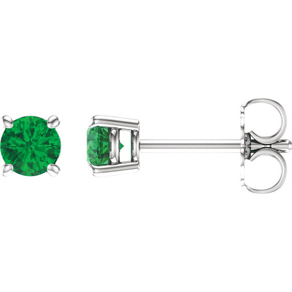 Delicate in design, these petite emerald stud earrings feature a pair of hand-selected classic green emeralds complemented by 14k white gold four-prong settings.