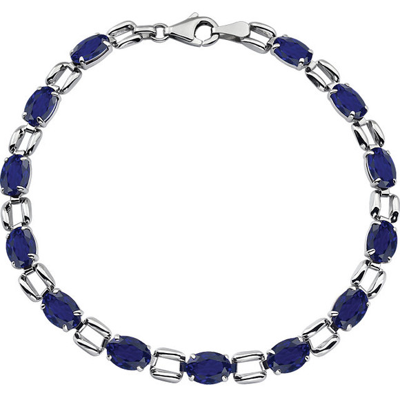 Fashioned in 14K White Gold, this eye-catching bracelet is lined with glistening 07.00x05.00mm genuine blue sapphires - a colorful take on tradition. Polished to a brilliant shine, this is a 7.00 inch bracelet.