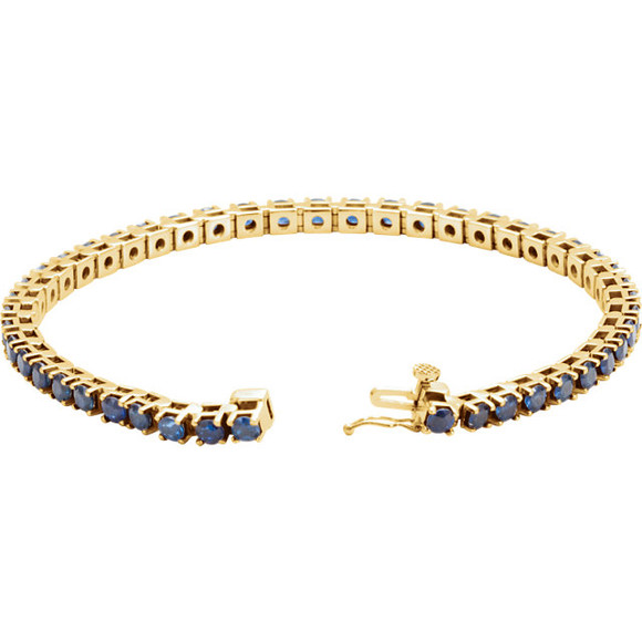 Striking in design, this petite sapphire 7.00" bracelet features 46 rich blue sapphires set in 14k yellow gold with a box catch clasp and hidden safety.