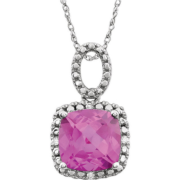 Exquisite 14Kt white gold pendant captures the beauty of a genuine 9.00mm cushion cut created pink sapphire accented by white shimmering diamonds hanging from an 18" inch chain. Total weight of the diamonds is 0.03 total carat weight.
