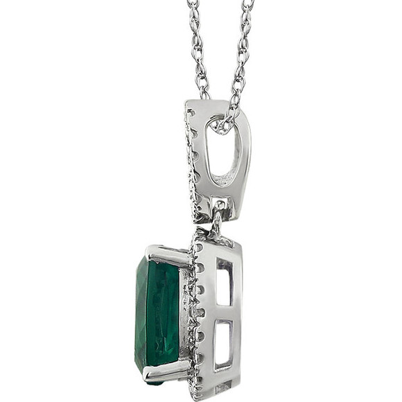 Exquisite 14Kt white gold pendant captures the beauty of a genuine 9.00mm cushion cut created emerald accented by white shimmering diamonds hanging from an 18" inch chain. Total weight of the diamonds is 0.03 total carat weight.