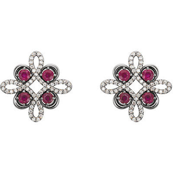 Beautiful 14Kt white gold clover earrings featuring eight gorgeous rubies and 1/4 total carat weight of diamonds. 