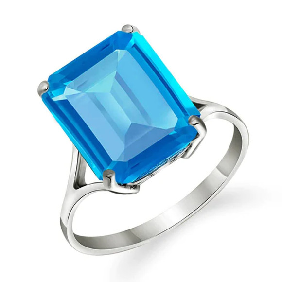 This very lovely 14k gold ring features a dazzling natural octagon blue topaz. The stone seems to flash with light and is held securely in place with a four-prong 14k gold setting. The precise octagon cut displays the vivid, deep blue color of the stone. The gemstone measures nearly one inch in height. The large stone, coupled with the gleaming gold setting, is sure to attract some attention during a night out on the town. The simple yet elegant ring setting comes in your choice of white, rose or yellow gold.