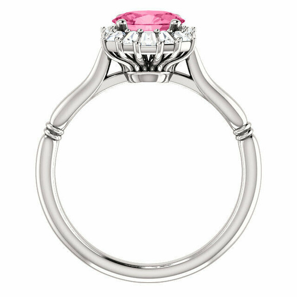Crafted in platinum, this ring features one oval Genuine Pink Tourmaline gemstone accented with 18 genuine diamonds. 