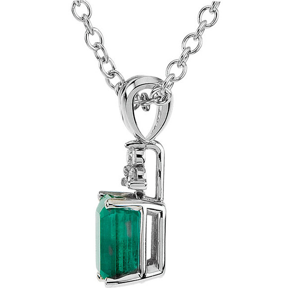 An genuine emerald is topped with three diamonds and set in 14k white gold. This beautiful necklace is great to wear alone or as a layered look.