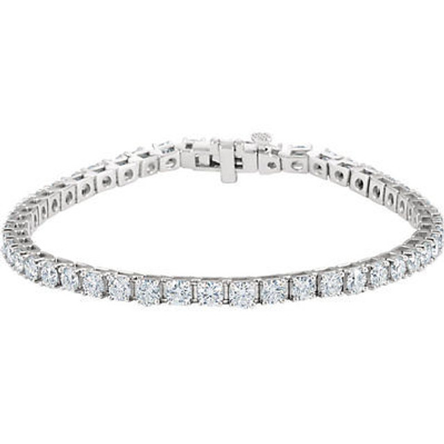 This fabulous 7.00 ct. t.w. diamond tennis bracelet is a breathtaking piece that we really love. Sparkling and sensational, it's a classic that features a stream of round full cut diamonds so gorgeous that it will have heads turning for a second look. 18kt white gold bracelet. 