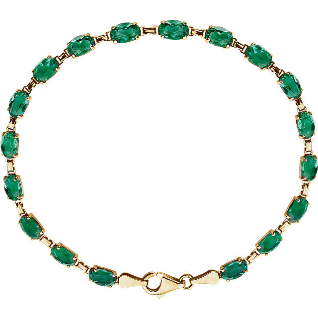 Brilliant oval created emeralds are set in 14k yellow gold in this eye-catching 7" bracelet. 