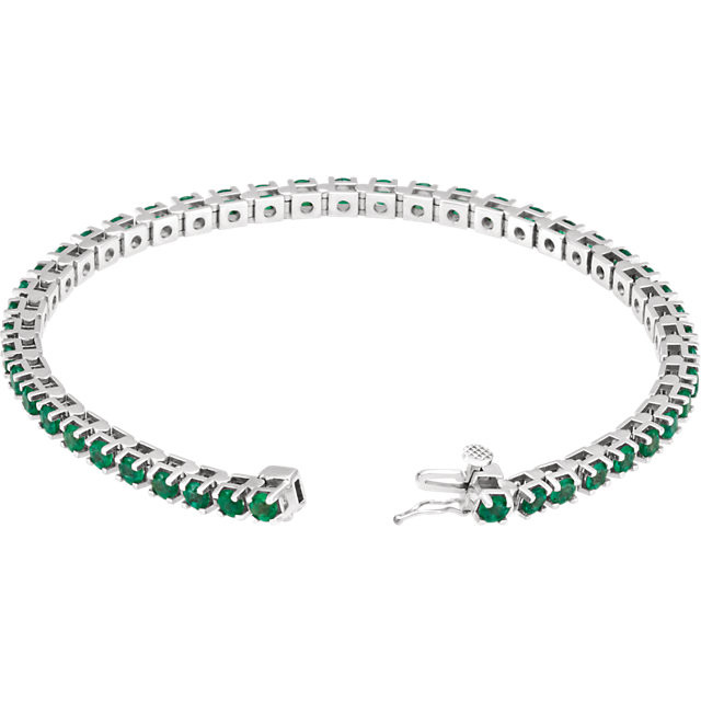 A dazzling complement to any style, this classic gemstone 7" bracelet showcases 46 vibrant round shaped emeralds in 14k white gold. Polished to a brilliant shine.