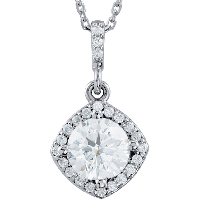 An impressive round diamond framed in additional round diamonds is the focal point of this extraordinary necklace for her. The pendant, fashioned in 14K white gold, is suspended from an 18-inch chain secured with a spring ring clasp. The total diamond weight is 7/8 carats.