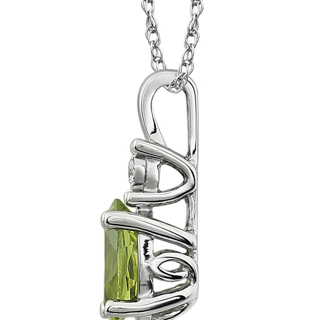 Exquisite 14Kt white gold pendant captures the beauty of a genuine 7x5mm oval Peridot accented by white shimmering diamonds hanging from an 18" inch necklace. Total weight of the diamonds is 0.02 total carat weight.