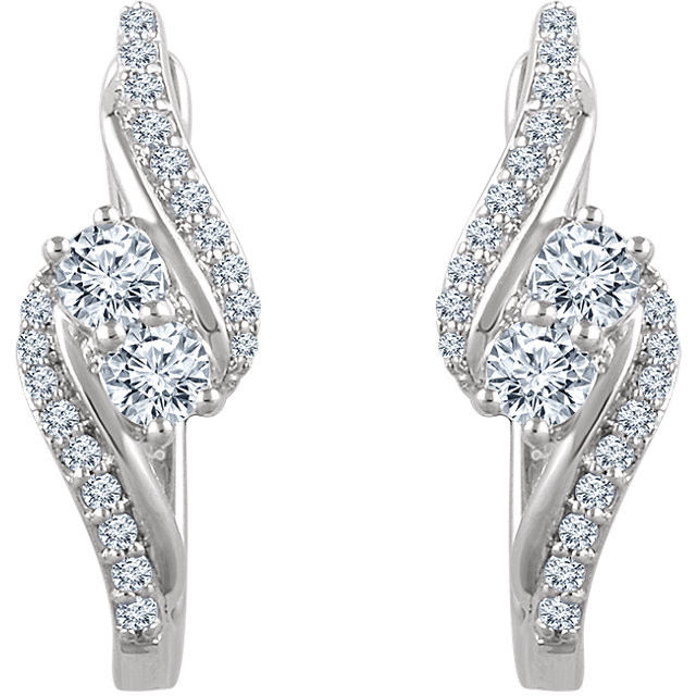 Celebrate your life together with these exquisite diamond hoop earrings. Crafted in 14K white gold, these meaningful designs each features two shimmering 1/6 ct. diamonds, representing both your friendship and loving commitment, nestled side-by-side at the center. Gracefully bypassing diamond-lined ribbons surround this glistening duo, wrapping it in a sparkling embrace. A brilliant metaphor for your romantic love story, these earrings captivate with 5/8 ct. t.w. of diamonds and a bright polished shine. The earrings secure comfortably with hinged backs.