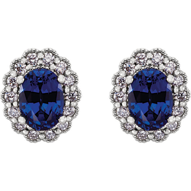 Exquisite platinum earrings capturing the beauty of radiant created blue sapphires and a total carat weight of 3/8 total carat weight of diamonds.