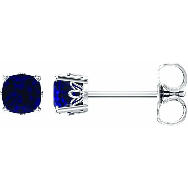 Sapphires prized for their intense velvety color and the calming influence of blue has made it an enduring symbol for loyalty and trust, which also makes it the perfect gift to represent a faithful and steadfast commitment. This simple stud design features a 6 x 6mm cushion-lab grown blue sapphire cradled in a 4-prong basket of 14k white gold finished with a friction back post.