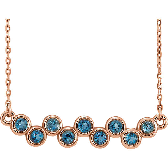 Beautiful 14Kt rose gold graduated bezel set aquamarine necklace hanging from a 16-18" inch chain which is included.