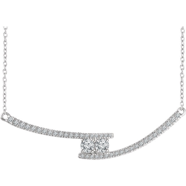 Chic and sparkling, this diamond two stone necklace features round diamonds in 14k white gold, and a matching cable chain. This necklace can be worn at 16 or 18 inches in length.