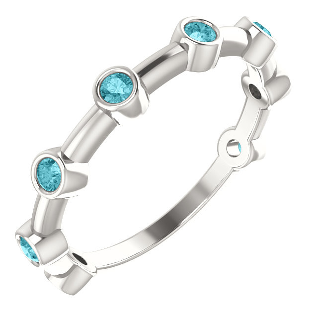 Crafted in platinum, this ring features 8, round, blue zircon gemstones. 
