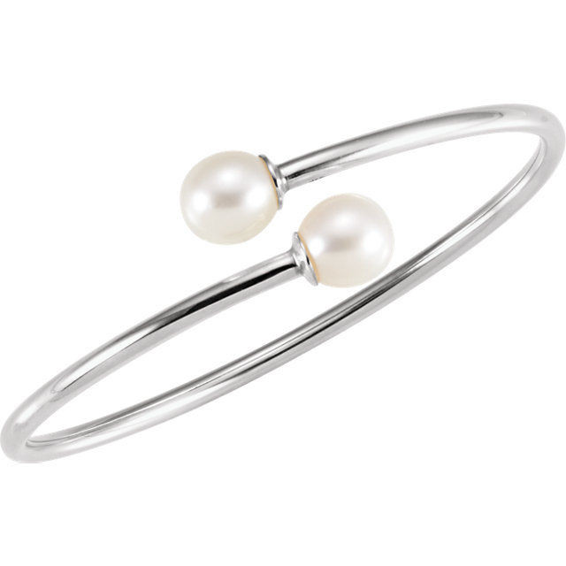 This beautiful bangle bracelet features one 9.5-10mm round Freshwater Cultured Pearl at each end. This flexible bracelet is made in Sterling Silver and measures 7 inches long with a 20mm width.