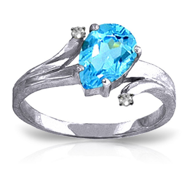 Those who love large sparkly gemstones will fall in love with this beautiful 14k solid gold ring with diamonds and blue topaz. The solid gold band has a unique design that looks stylish on any finger. The main focus of this gorgeous ring is the 1.5 carat stunning pear shaped blue topaz stone. The size of the stone isn't overwhelming, but allows it to stand out wherever it is worn. This piece also features two small round diamonds set in the band to accent the beauty of the shimmering blue stone. This is the perfect piece for anyone who loves beautiful rings, as well as for those born in the month of December to really showcase their birthstone to the world.