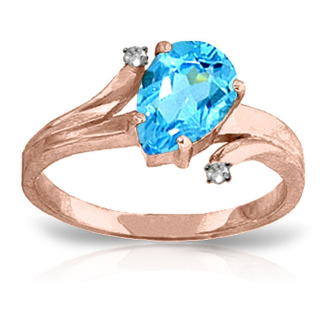 Those who love large sparkly gemstones will fall in love with this beautiful 14k solid gold ring with diamonds and blue topaz. The solid gold band has a unique design that looks stylish on any finger. The main focus of this gorgeous ring is the 1.5 carat stunning pear shaped blue topaz stone. The size of the stone isn't overwhelming, but allows it to stand out wherever it is worn. This piece also features two small round diamonds set in the band to accent the beauty of the shimmering blue stone. This is the perfect piece for anyone who loves beautiful rings, as well as for those born in the month of December to really showcase their birthstone to the world.