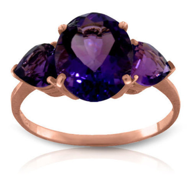 This 14k gold ring with natural amethyst makes a splendid birthday gift for those celebrating in February. This ring brilliantly displays the gorgeous February birthstone that has a classically beautiful look. One oval shaped center stone weighs an amazing three carats for extra sparkle to make her light up. Two radiant heart shaped amethyst stones flank either side of the center stone, adding another carat of beautiful bright purple. The simple white gold band pulls the piece together nicely to make it a classic favorite.