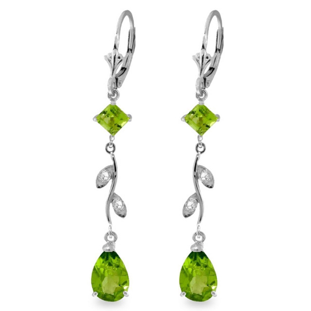 This pair of 14k gold chandelier earrings with diamonds and peridot cascades with brilliance and elegance. These earrings incorporate a variety of different shapes to give these jewels a unique look. Four round cut diamonds, two square shaped period, and two pear shaped peridot stones add shine and glamor to these fabulous earrings. The classic leverback style allows these earrings to be worn with ease and comfort. This versatile pair of earrings is a perfect addition to any fine jewelry lover's collection.