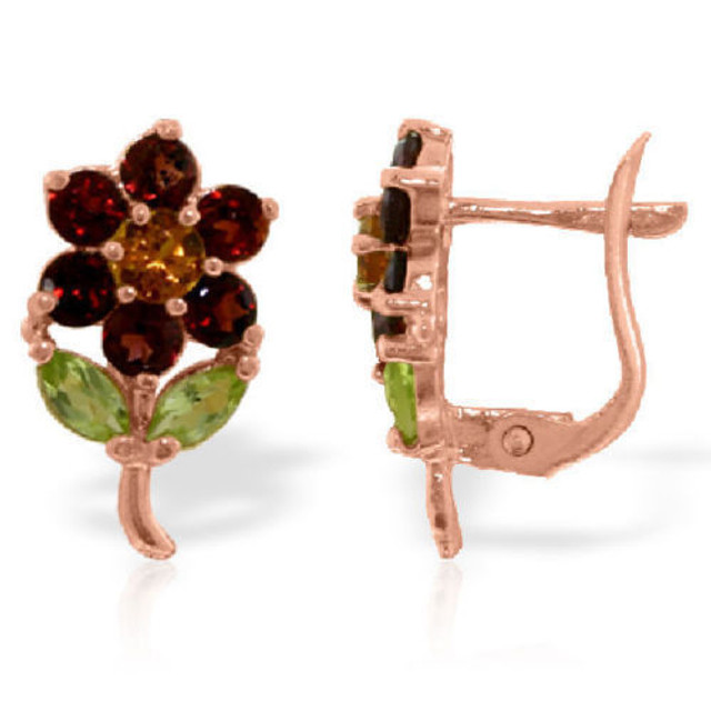 These whimsical 14k gold flower stud earrings with garnets, citrines and peridots will make you smile when you wear them. Each of the petals is made up of deep-red garnets. The center of the flower is a lovely citrine stone. The leaves are the marquis-shaped peridots. The setting of the earrings forms the stem and holds these delicate stones in place. In total, all of the stones equal a whopping 2.12 carats. These earrings fit comfortably, you even likely to forget you have them on. These earrings make the perfect gift for a grandmother, an aunt, your mother or anyone else that loves flowers and earrings.