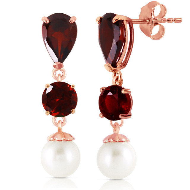 With these 14k solid gold chandelier earrings with garnets and pearls, the lovely depth and beauty of garnets is offset by the pure white appearance of pearls. Those who love to mix and match their gemstones will love the elegant look that these stylish earrings have to offer. Five carats of pearls and five and a half carats of gorgeous natural garnets set in real gold makes these earrings look and feel rich and luxurious. At over one inch long, they dangle dramatically from the earlobes, ensuring that they are always seen.
