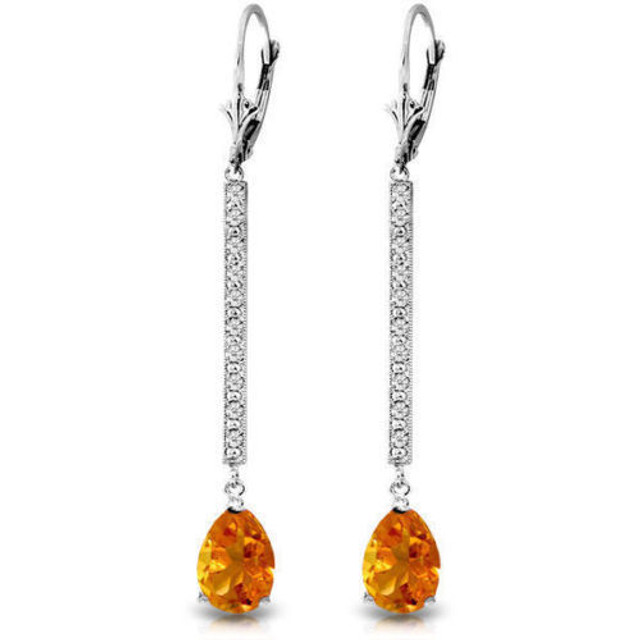  These glamorous 14K gold Earrings with Diamonds & Citrines are sure to make you feel like a celebrity on the red carpet. Each earring hangs in a long swoop about 2.18 inches from the earlobe. Twenty round-cut diamonds decorate these earrings and are a total of 0.10 carats. They have K-M color and Sl-2 clarity. The pear-shaped citrines are a total of 3.50 carats. These earrings are certainly blingy and bright when in direct sunlight or artificial light. These long-drop earrings are definitely designed for special occasions, and will make the perfect piece to wear for a fancy upscale dinner or a night out on the town.