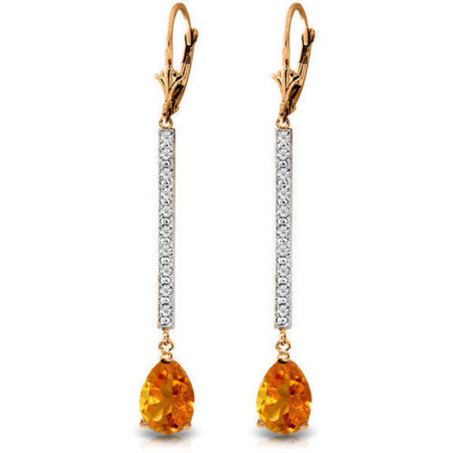  These glamorous 14K gold Earrings with Diamonds & Citrines are sure to make you feel like a celebrity on the red carpet. Each earring hangs in a long swoop about 2.18 inches from the earlobe. Twenty round-cut diamonds decorate these earrings and are a total of 0.10 carats. They have K-M color and Sl-2 clarity. The pear-shaped citrines are a total of 3.50 carats. These earrings are certainly blingy and bright when in direct sunlight or artificial light. These long-drop earrings are definitely designed for special occasions, and will make the perfect piece to wear for a fancy upscale dinner or a night out on the town.