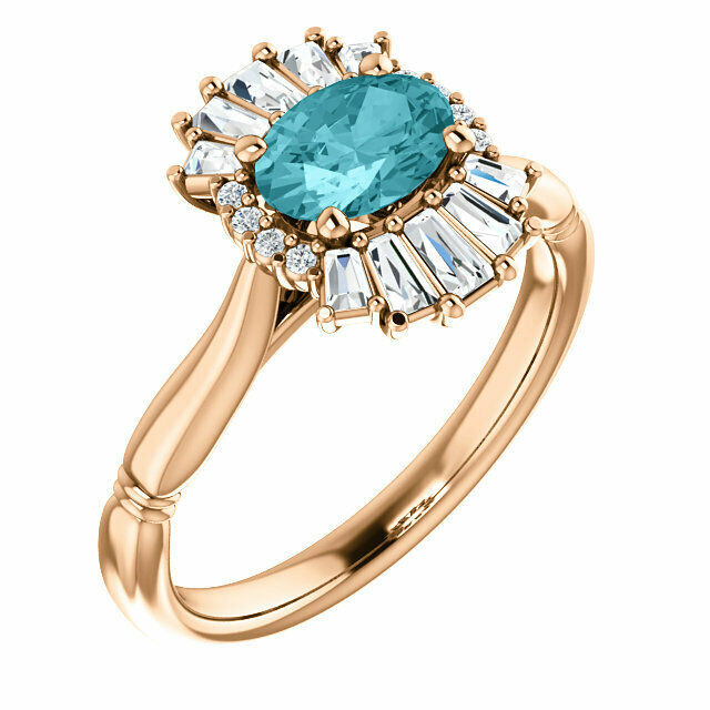 Crafted in 14k rose gold, this ring features one oval Genuine Blue Zircon gemstone accented with 18 genuine diamonds. 