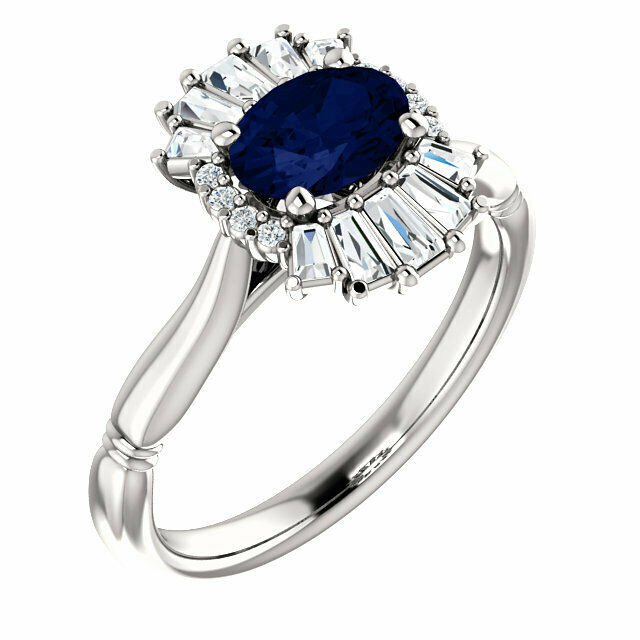 Crafted in 14k white gold, this ring features one oval Chatham Created Blue Sapphire gemstone accented with 18 genuine diamonds. 