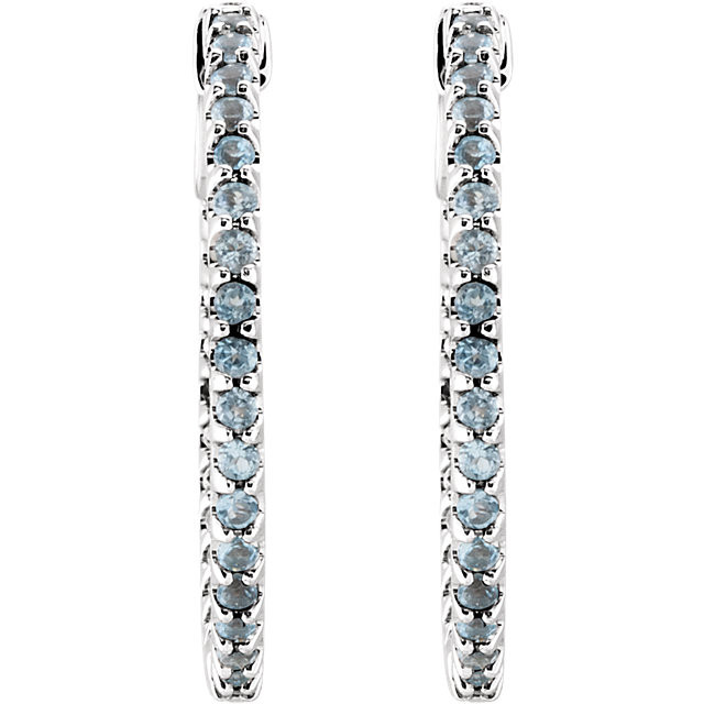 Perfect for the woman who appreciates color, these hoop earrings will take her breath away. Fashioned in 14K White Gold, these hoop earrings are set with shimmering round regal sky blue topaz gemstones along the inside and outside edges. With color and sparkle evident from every angle, these earrings are a great look any time. Polished to a brilliant shine, these earrings secure with hinged backs.