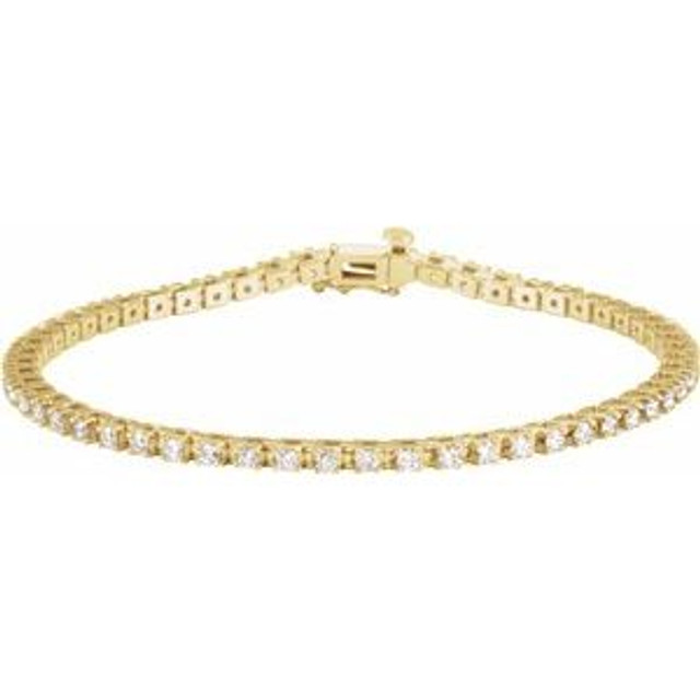 Sparkling, lab grown diamonds are set in a classic 14k yellow gold, four-prong 7.25" tennis bracelet.