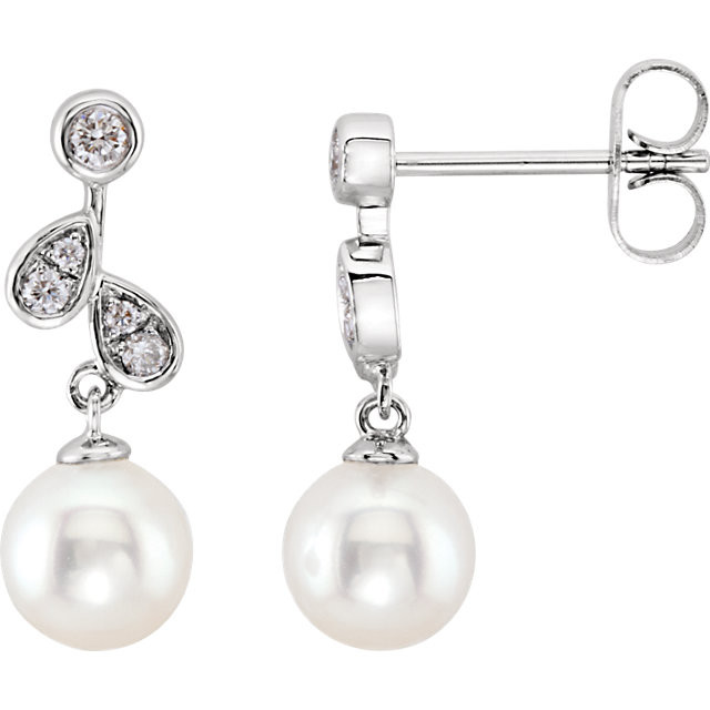 These elegant 14k white gold earrings each feature a white freshwater pearl drop with diamond accents. Diamonds are 1/6ctw, H-I in color, and I1 or better in clarity. Earrings are 18.39mm in length and 6.44mm in width.