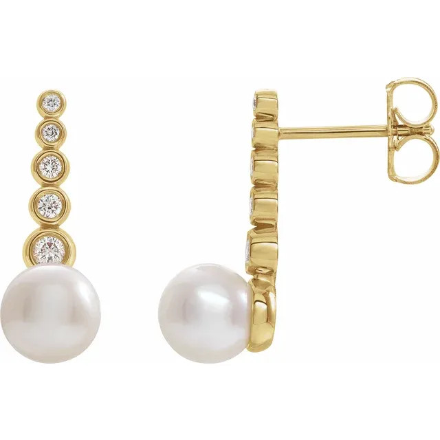 These beautiful pearl earrings feature two lustrous AA+ quality 5.5-6.0mm white freshwater pearls. The pearls are mounted on 14k yellow gold with dazzling I1 clarity diamonds. 