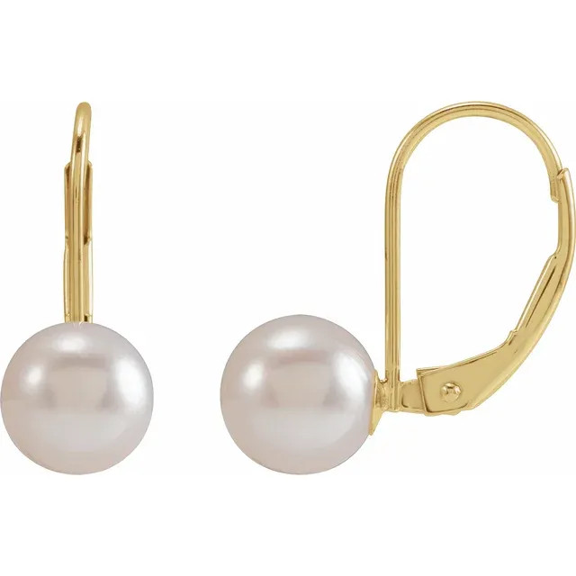 With ease and elegance, these classic pearl drop earrings complete her tailored anytime attire.