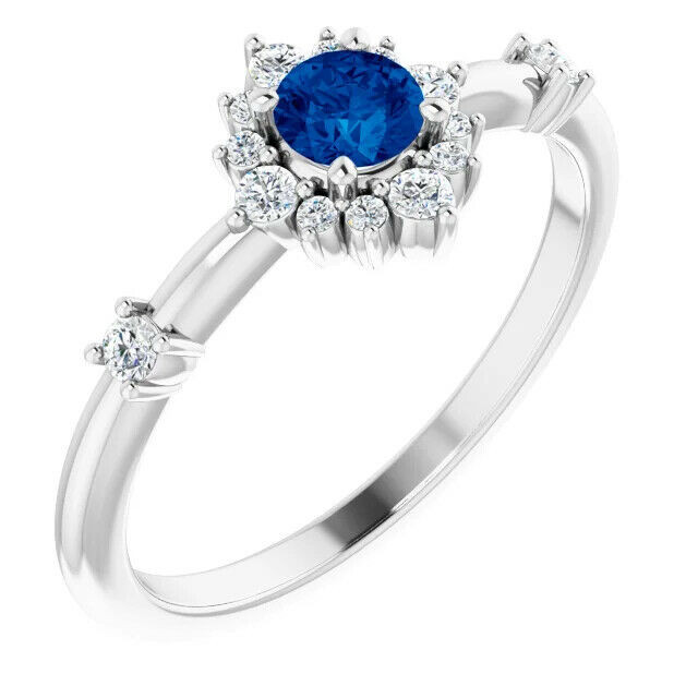 Take your look to the next sophisticated level when you wear this charming round-shaped blue sapphire and diamond ring in white gold.