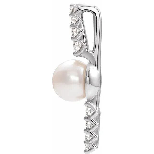 Make a bold and modern fashion statement with this cultured freshwater pearl & Diamond Pendant in 14k white gold showcased by 8 sparkling accent diamonds set off by a singular freshwater cultured freshwater pearl.

Cultured freshwater pearls measure approximately 6mm to 6.5mm in diameter. Diamonds are rated I1 for clarity, G-H for color, with 1/6 total carat weight. 