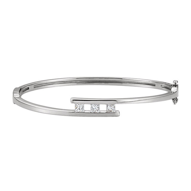 This 14K white gold fine bangle bracelet features three square princess diamonds in a prong setting. The bangle is 7.0 inches in circumference.