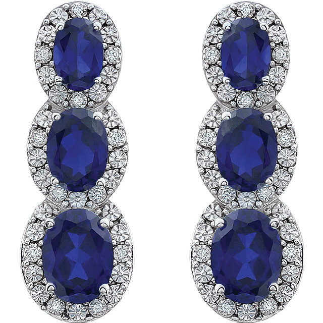 Bold and brilliant, these drop earrings are a sparkling look, perfect for that special evening out. Crafted in cool 14K white gold, each earring features three created blue sapphire set one atop the other, creating a glittering linear look. Radiant with .07 cts. t.w. of diamonds and polished to a brilliant shine, these post earrings secure comfortably with friction backs.