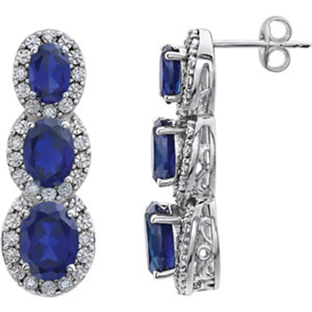 Bold and brilliant, these drop earrings are a sparkling look, perfect for that special evening out. Crafted in cool 14K white gold, each earring features three created blue sapphire set one atop the other, creating a glittering linear look. Radiant with .07 cts. t.w. of diamonds and polished to a brilliant shine, these post earrings secure comfortably with friction backs.