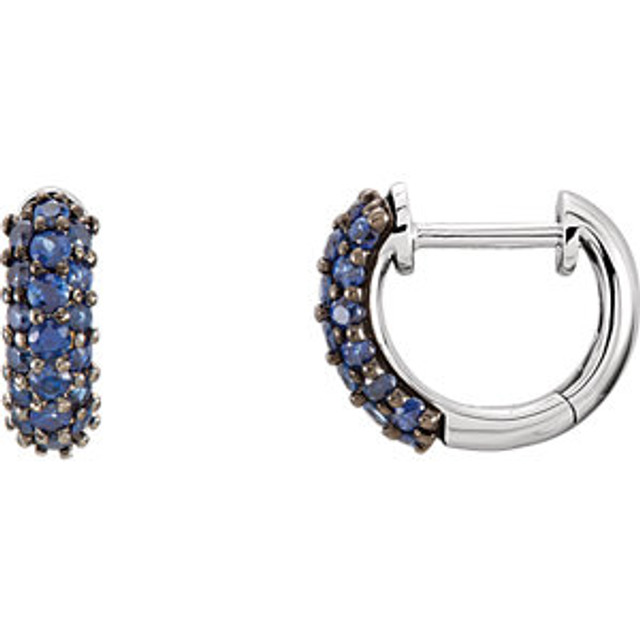 Sapphires prized for their intense velvety color and the calming influence of blue has made it an enduring symbol for loyalty and trust, which also makes it the perfect gift to represent a faithful and steadfast commitment. This colorful hinged hoop design features thirty-eight genuine sapphires prong set in 14k white gold. These small huggie style earrings are approximate 2.5mm in width by 10mm (3/8 inch) in length. Total gemstone weight for the pair is 0.85 carat. Color range varies on all natural stones so please allow for slight variations in shades. Gemstone treatment: natural, not enhanced.