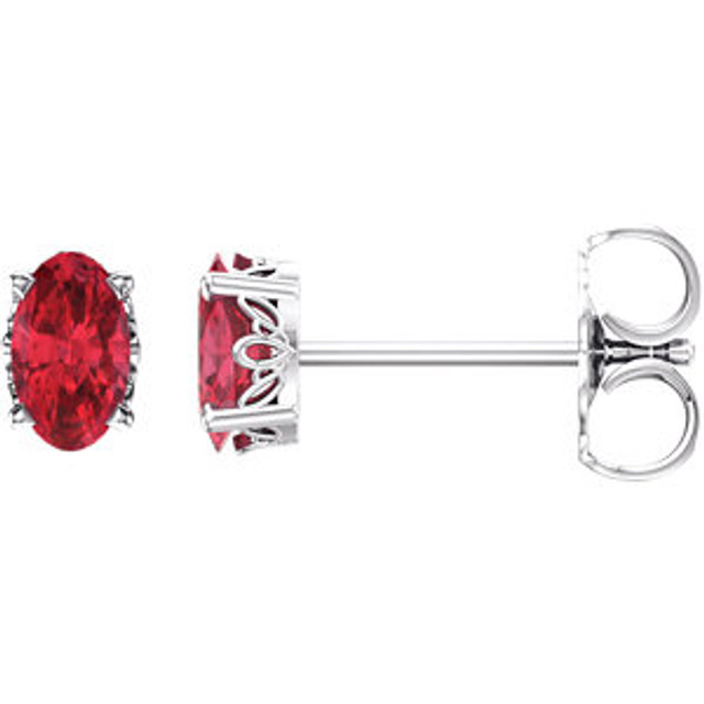 Fiery and romantic! This simple stud design features a 5 x 3mm faceted Chatham-created ruby cradled in a 4-prong basket of 14k white gold finished with a tension back post. Total carat weight for the pair is 0.60.