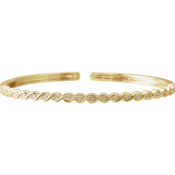 This bangle bracelet showcases round diamonds flush set in 14k yellow gold. Total weight of the diamonds is 1/6cts. Total weight of the gold is 14.49 grams.