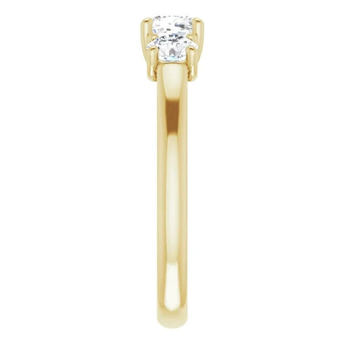 This stunning Forever One™ Moissanite Three-Stone Engagement Ring is crafted in 14K yellow gold and features a 5.0mm center stone flanked by two 4.0mm side stones.