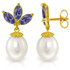  Look beautiful in these white gold dangling earrings with pearls and tanzanite stones. These earrings have a stunning regal quality. After all, purple, found in the tanzanite stones, is the color of royalty. These luxurious earrings are made of high quality 14 karat gold. The earrings come in classic yellow gold, antique rose gold and icy white gold.

The tanzanite gemstones and pearls look splendid with any combination. Each earring has three tanzanite stones that create a stunning petal effect. The marquise shaped stones frame the crown tanzanite stone. The pearls, on each earrings, are in a classic pear shape. These earrings have a lovely Victorian feel.