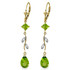 This pair of 14k gold chandelier earrings with diamonds and peridot cascades with brilliance and elegance. These earrings incorporate a variety of different shapes to give these jewels a unique look. Four round cut diamonds, two square shaped period, and two pear shaped peridot stones add shine and glamor to these fabulous earrings. The classic leverback style allows these earrings to be worn with ease and comfort. This versatile pair of earrings is a perfect addition to any fine jewelry lover's collection.