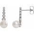 These beautiful pearl earrings feature two lustrous AA+ quality 5.5-6.0mm white freshwater pearls. The pearls are mounted on sterling silver with dazzling I1 clarity diamonds. 