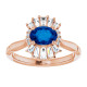 Crafted in 14k rose gold, this ring features one oval Genuine Blue Sapphire gemstone accented with 18 genuine diamonds.